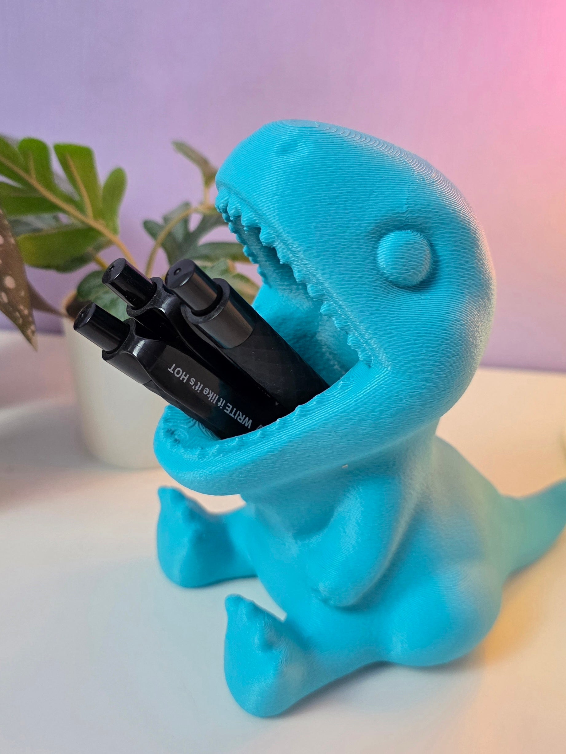 Pennenbakje in de vorm van een dino met de mond open