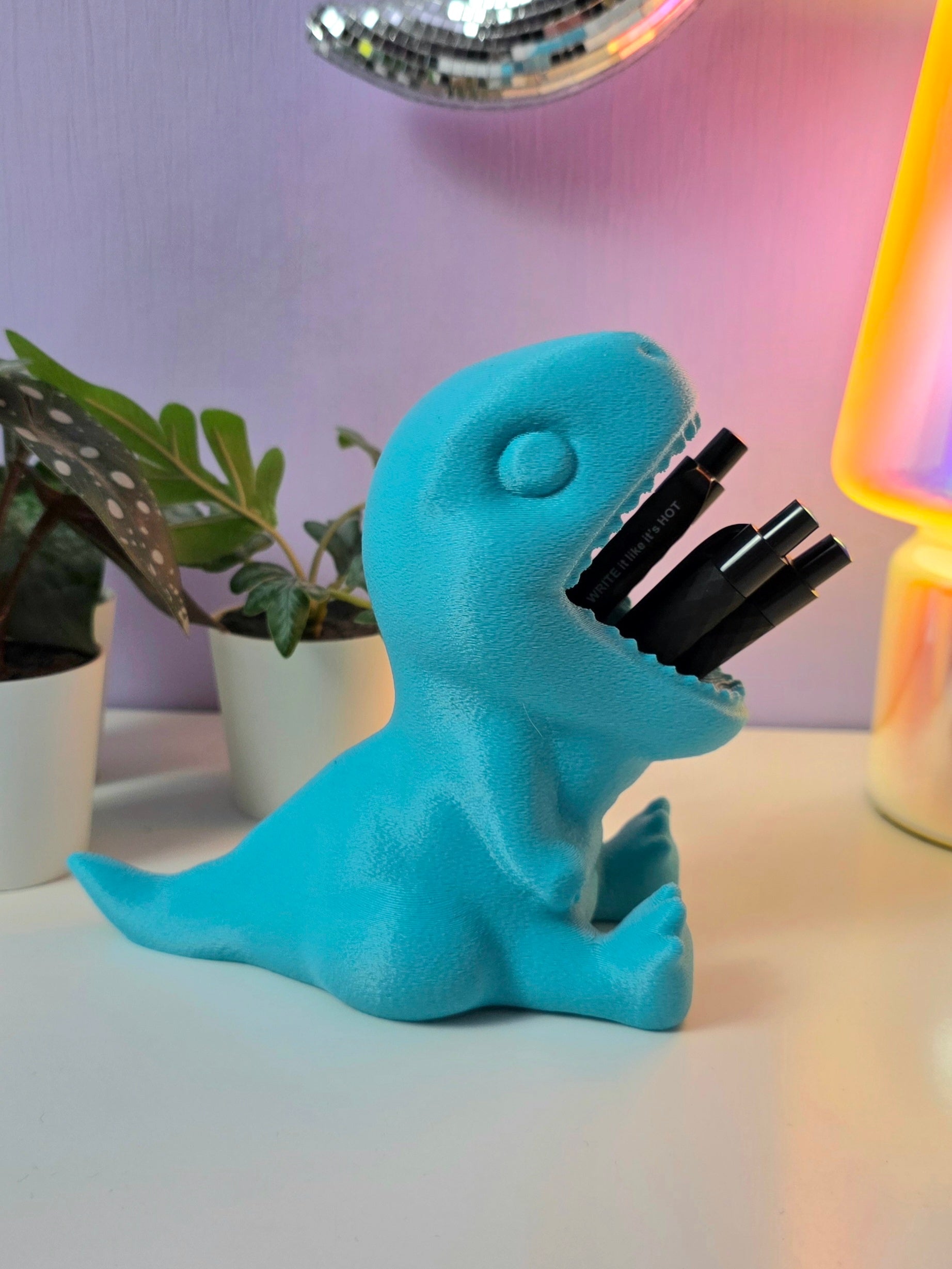 Pennenbakje in de vorm van een dino met de mond open